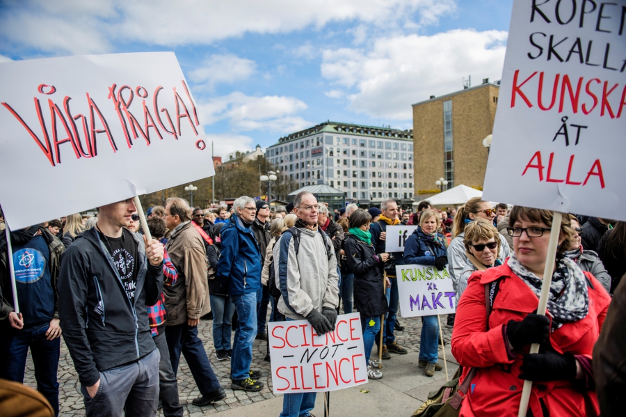 Demonstrators hold placards during the "March for Science Stockholm" at Medborgarplatsen square in Stockholm, Sweden April 22, 2017.
